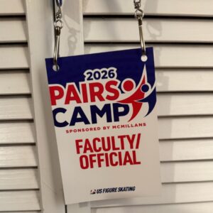 Close-up of Caralee Hammer Frederic's faculty credential for the 2026 U.S. Figure Skating McMillan Pairs Camp.