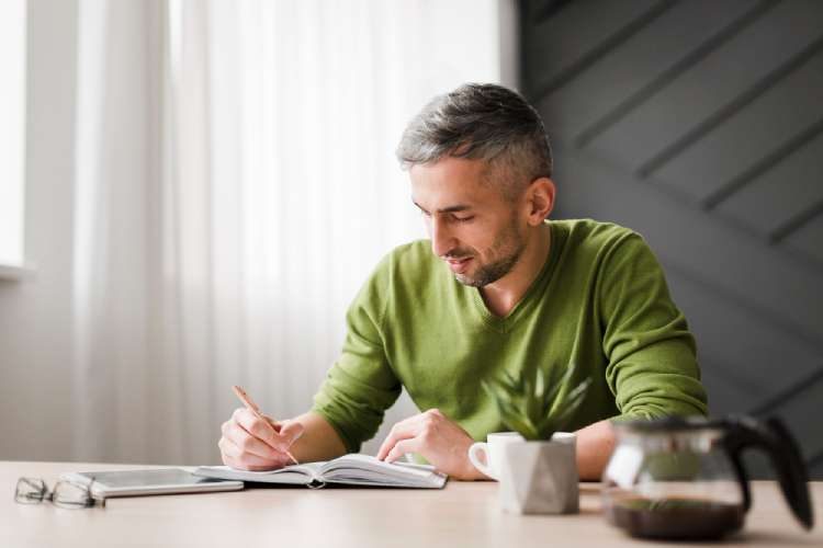 A therapist studies Gottman Method training materials while preparing for certification.